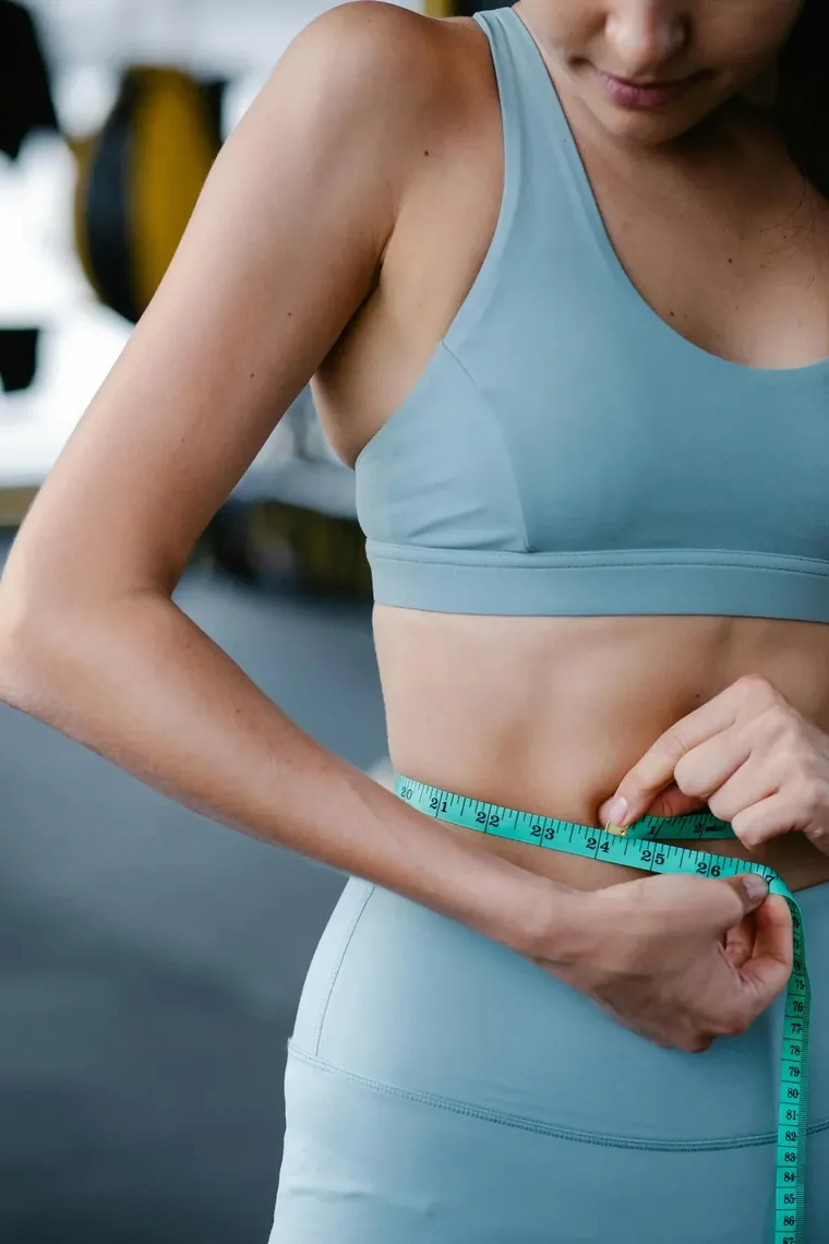 Stock photograph of a tape measure held at the waist