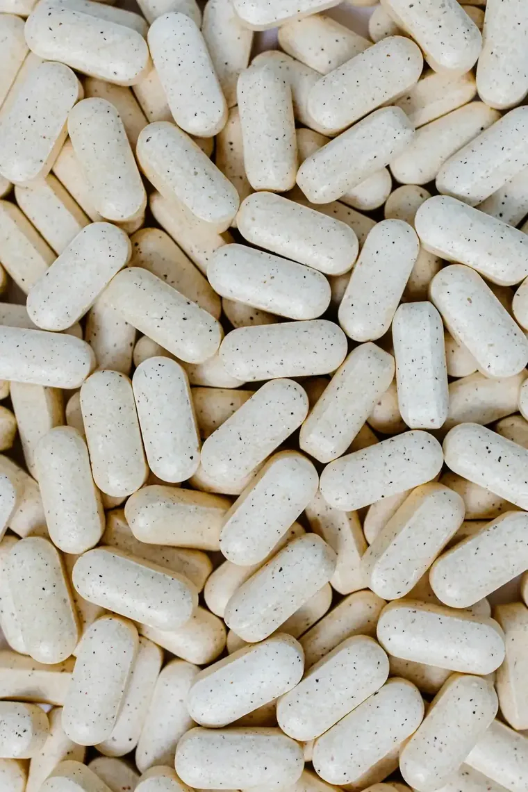 A dense pile of pale capsules